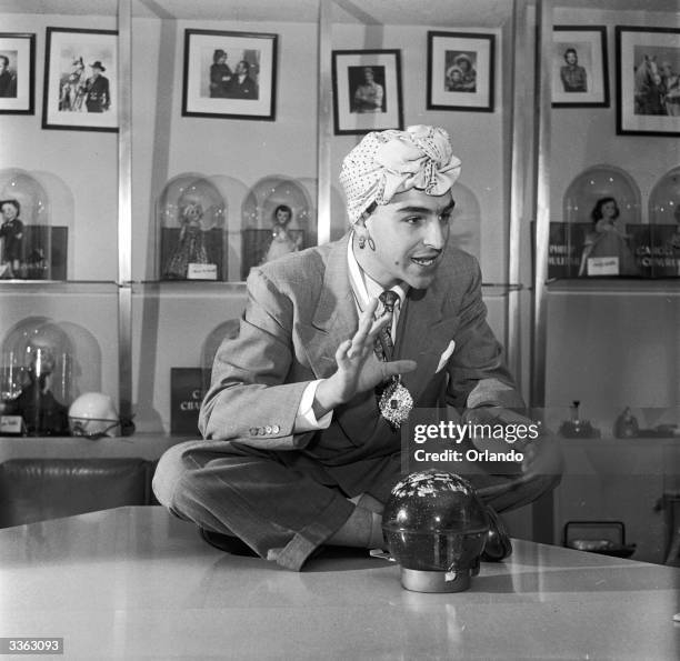 Crystal ball prediction toy, with its inventor dressed as a fortune teller, on Inventor's day at the Ideal Toy Co, Hollis, New York.