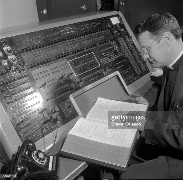 Rev Ellison, technical consultant on the Univac project working on a control panel which gives direct access to Univac. This allows him to see...