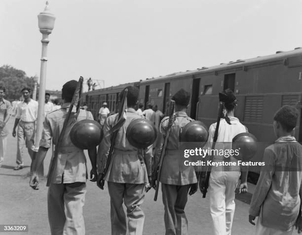 Muslim League National Guards on a platform at a railway station in New Delhi, India, August 1947. They are helping with the departure of six hundred...