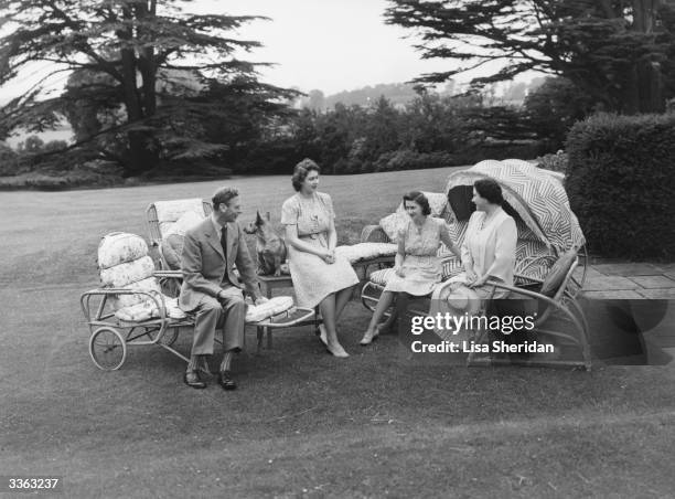 The Royal family sit relaxing in the grounds of the Royal Lodge, Windsor , King George VI , Princess Elizabeth, Princess Margaret Rose and Queen...