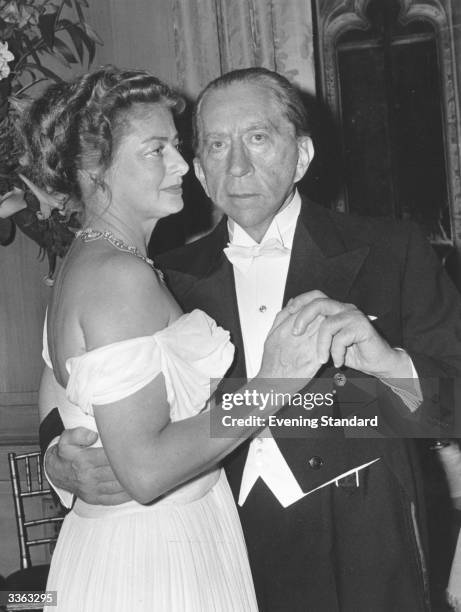 American oil executive and financier J. Paul Getty with Mary Teissier at a party at his home Sutton Place, Surrey.