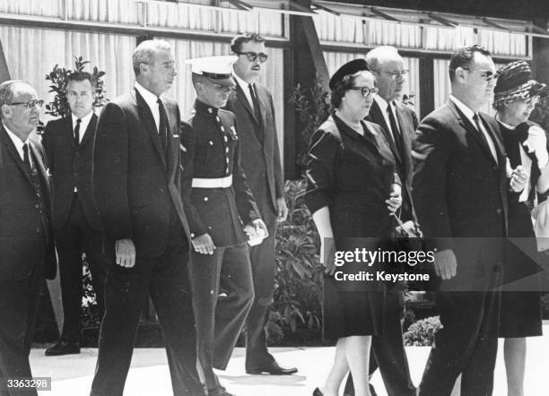 American baseball player Joe DiMaggio attends the funeral of film star Marilyn Monroe with his son Joe Junior and Monroe's half-sister Bernice...