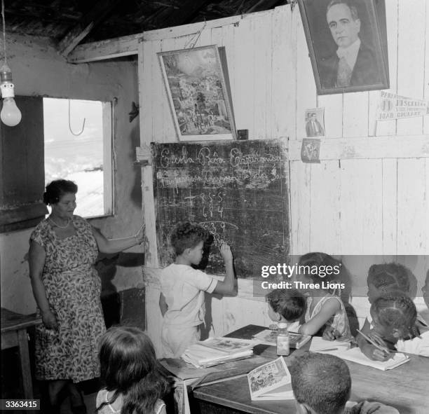 Portrait of the late Brazilian president GetulioVargas looks down upon an arithmetic class in the Moro da Gamboa favela, or shanty town, on a...