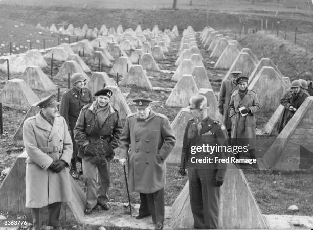 British Prime Minister Winston Churchill visits the US 9th Army as they cross the concrete barrier of the Siegfried Line or West Wall into Germany,...