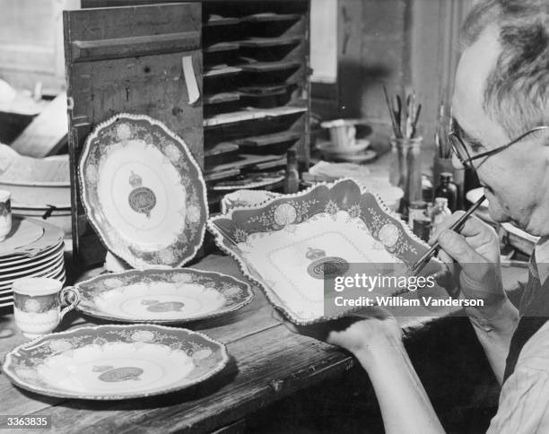 An artist painting a fruit dish which will form part of a display at St James Palace for the wedding of Princess Elizabeth and The Prince Philip,...