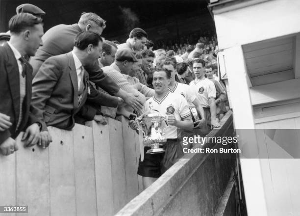 Supporters congratulate Bolton captain Nat Lofthouse, as he leads his team down the steps with theFA Cup trophy, after Bolton Wanbderers' 2-0 victory...