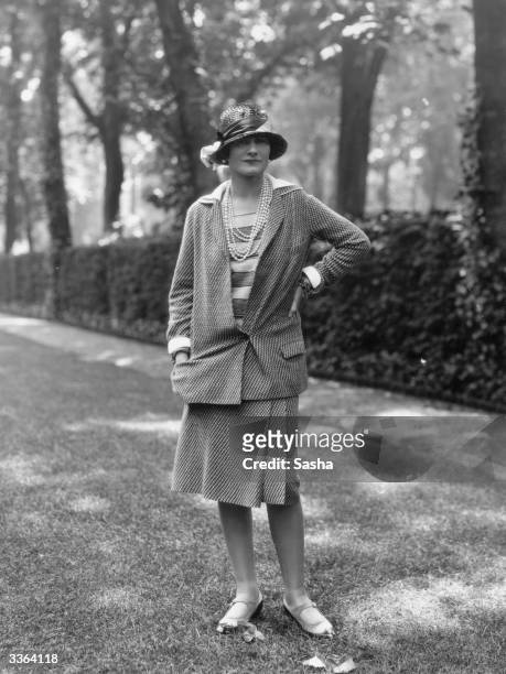 Influential French fashion designer Coco Chanel, real name Gabrielle Bonheur Chanel, modelling a Chanel suit at Fauborg, St Honore, Paris.