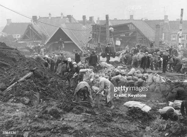 Rescue workers at the scene of the wrecked Pantglas Junior School at Aberfan, South Wales, where a coal tip collapsed killing over 190 children and...