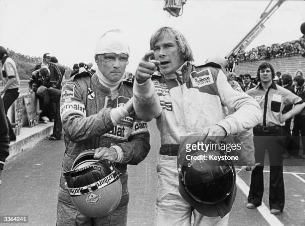 Racing drivers Niki Lauda and James Hunt after both were involved in a multiple collision and forced to retire at the start of the Belgian Grand Prix...