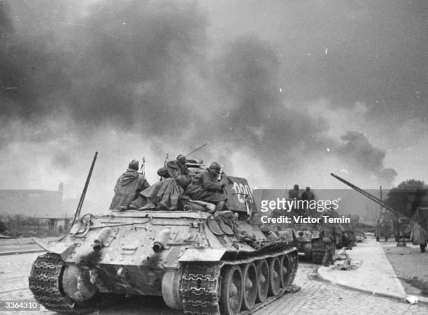 Soviet troops aboard a T-34 tank. Dubbed, 'The Attached Infantry', their batallions endeavoured to protect tanks from anti-tank weaponry. The...