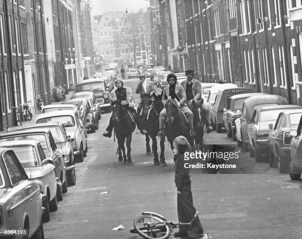 Four horsemen riding through the streets of Amsterdam on a 'motorless day', when cars are prohibited due to the oil crisis in the Middle East, 4th...