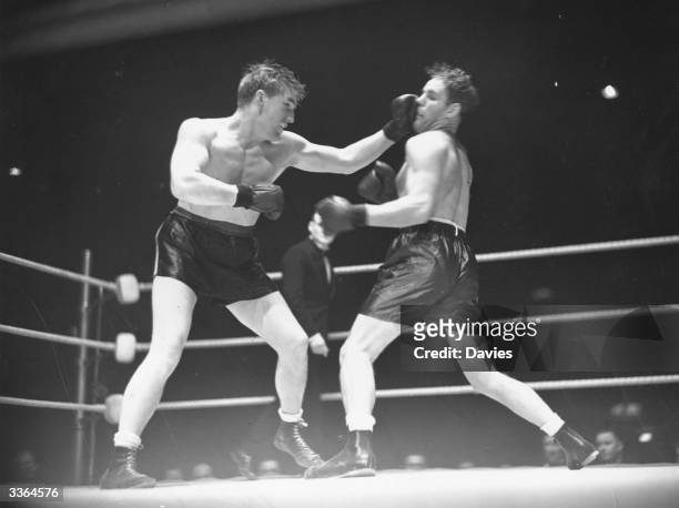 Welsh heavyweight boxing champion, Tommy Farr punching Clarence Burman during an international heavyweight contest at Harringay Arena, London,