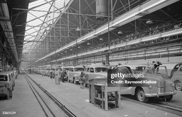 Workers assembling and polishing cars destined for export, at the Austin Motor Company's Longbridge plant in Birmingham. Original Publication:...