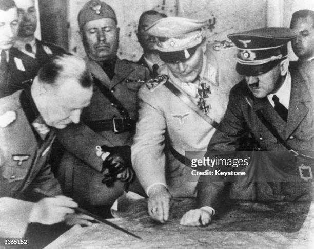 Adolf Hitler , Hermann Goering and others plan military strategy at the German Army Headquarters. In the background is Italian dictator Benito...