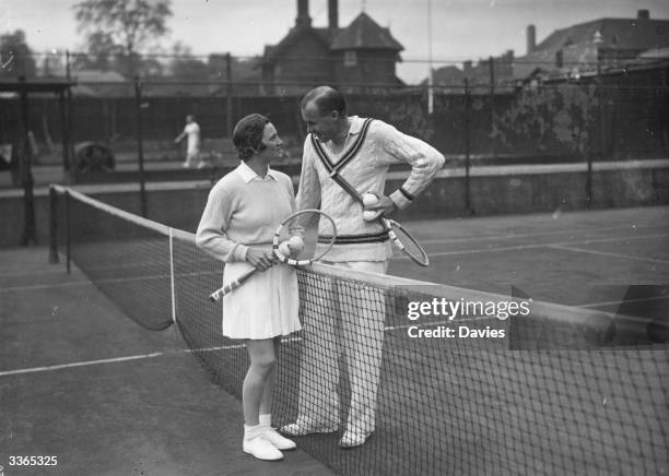 American tennis players Helen Jacobs and Bill Tilden chatting between practice games at the Melbury Club in London.