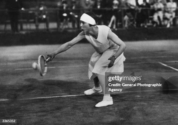 German tennis player Cilly Aussem in action playing a back hand.