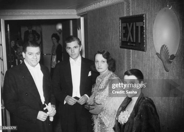 Librettist and songwriter Oscar Hammerstein II, left, and Canadian revue star Beatrice Lillie, right, attending the opening night of 'Wild December'...