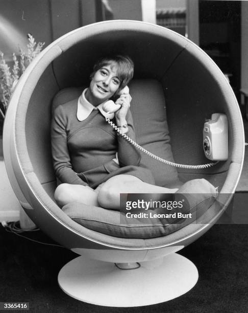 Julie Philpott from Surrey, sits comfortably in the Asco Bomb Chair, with a built-in telephone. The chair is on show at the 'Into The 70's'...