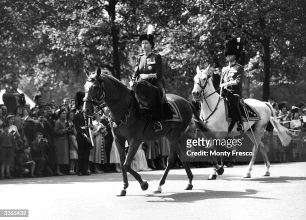 Queen Elizabeth II in front of Prince Philip, Duke of Edinburgh en route to Horse Guards parade, London for a Trooping of the Colour ceremony,