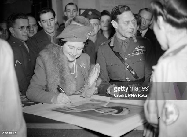 King George VI , and Queen Elizabeth visiting the American Red Cross Mostyn Club in London.