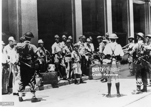 Japanese troops being rounded up by British forces in Hong Kong's dockyards. Under the command of Admiral Harcourt, British task forces have...