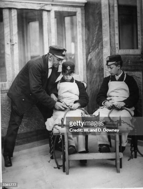 Young King George V with elder brother Albert Victor, Duke Of Clarence learning skills while cadets. After Albert's death George married his...