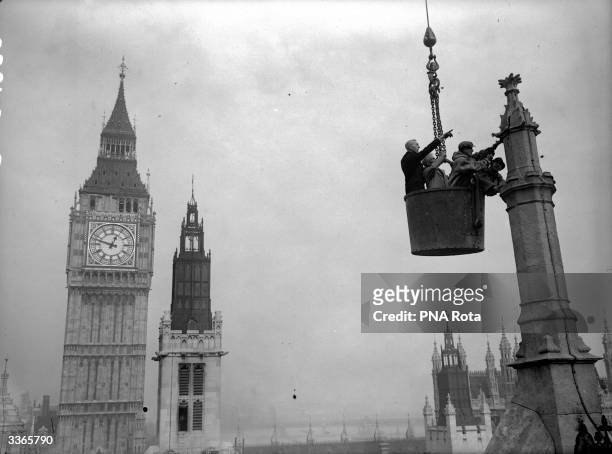 Workmen removing steel from the chamber of the House of Commons, London, to use for making tanks.