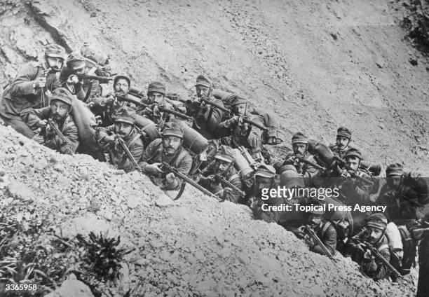 Italian soldiers in a trench on a mountain side, ready for action.