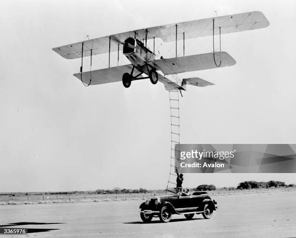 Stunt man climbs a ladder from a moving car to an aeroplane from the film 'The Great Waldo Pepper' directed by George Roy Hill and produced by...
