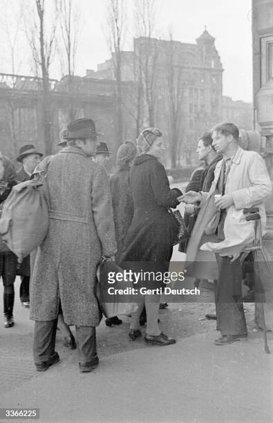 Austrian ex-servicemen selling black market goods. Original Publication: Picture Post - 4471 - In Vienna Today - A Foreign Correspondents Life - pub....