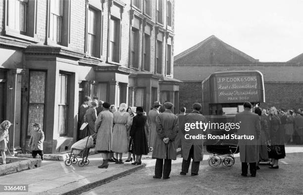 Crowds of the curious gather to watch as the contents are cleared from 10 Rillington Place, in London's Notting Hill, the home of multiple murderer...
