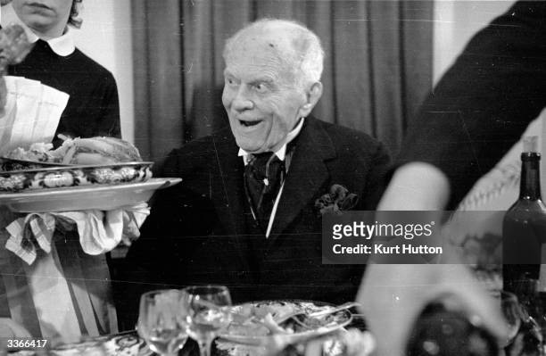 English author Henry Annesley Vachell at 91 likes the look of what is being offered him at a meal which lasted three and a half hours and included...