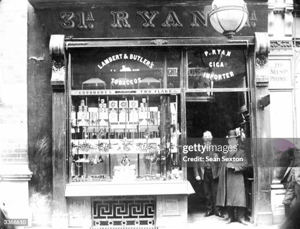 Two men in the doorway of Ryan's tobacconist at Henry Street, Dublin.