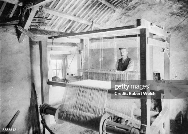 Man weaving a length of tweed using a hand loom in the Donegal Highlands.