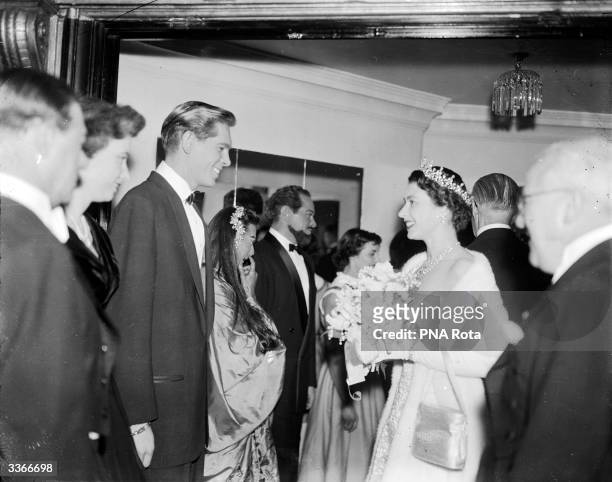 Queen Elizabeth II congratulates Johnnie Ray, 'The Nabob of Sob' on his singing, after attending the Royal Variety Performance at London's Victoria...