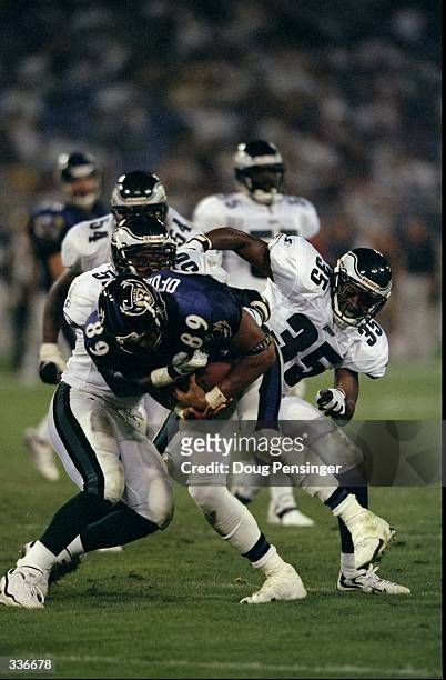Safety Anthony Marshall and line backer Mike Caldwell of the Philadelphia Eagles tackle A.J. Ofodile of the Baltimore Ravens during a pre-season game...