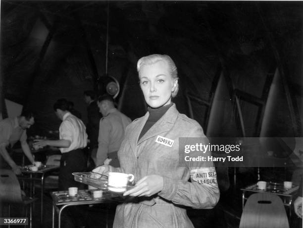 American screen actress Jan Sterling in character as Julia on the set at Elstree, during the filming of George Orwell's famous novel, '1984'. The...