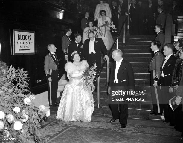 Queen Elizabeth , Queen Consort to King George VI leading her family down the steps of the Empire Cinema, Leicester Square, after watching the Royal...