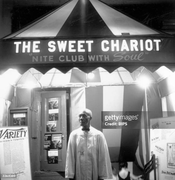 Doorman Buxie Keels stands at the entrance of The Sweet Chariot, a gospel music nightclub near Broadway, New York, billed as 'the nightclub with a...