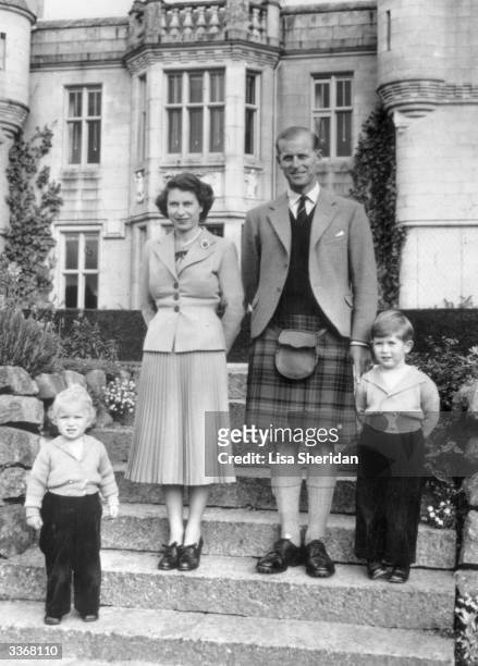 Queen Elizabeth II and The Prince Philip, Duke of Edinburgh with their two young children, Princess Anne and Prince Charles outside Balmoral Castle....