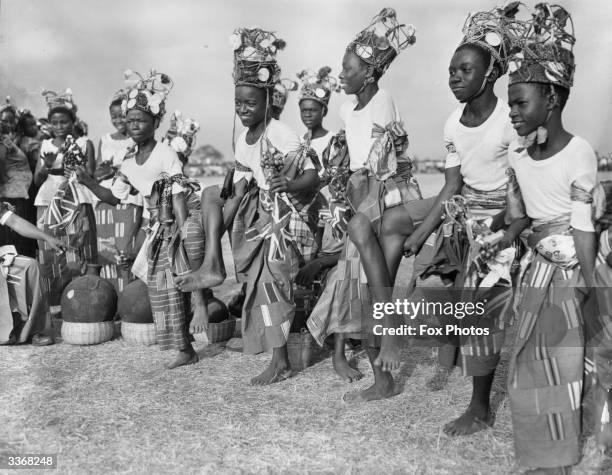 Group of Eastern Nigerian tribal dancers performing in traditional costume for the Queen during her Royal Tour.