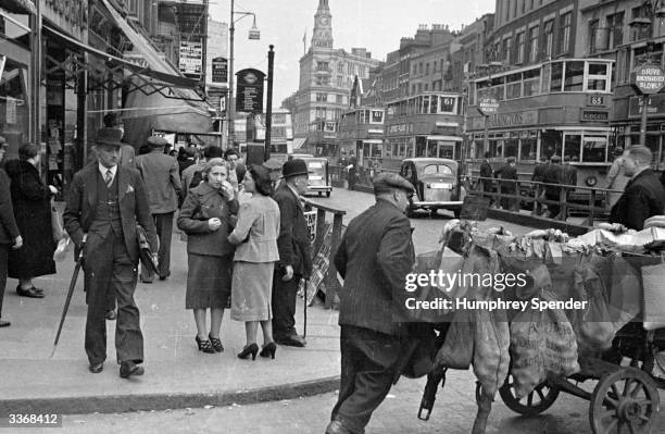 People in Whitechapel High Street in the East End of London. Original Publication: Picture Post - 27 - Whitechapel - pub. 1938