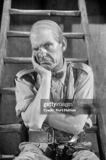 English comic actor Will Hay plays Professor Benjamin Tibbetts in the film 'Old Bones of the River', directed by Marcel Varnel and produced by...