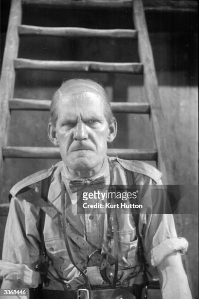 English comic actor Will Hay plays Professor Benjamin Tibbetts in the film 'Old Bones of the River', directed by Marcel Varnel and produced by...