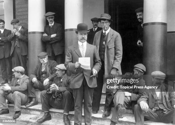 An applicant leaves Maritime Hall, the general office of the Amalgamated Stevedores Labour Protection League with a permit during the Great Transport...