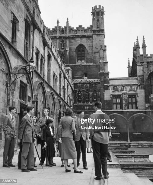 Group of students at Oxford University showing tourists how the university really lives for $8 which includes lunch, coffee and a trip to Eton....