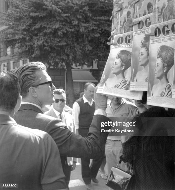 While in Rome for the filming of, 'Two Weeks in Another Town' directed by Vincente Minnelli, the actor Kirk Douglas stops to look at a picture of...