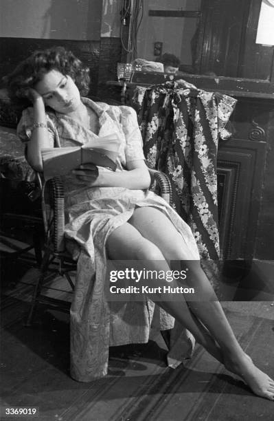 The actress Christabel Moore in her dressing room reading St John Ervine's play 'The First Mrs Fraser' in which she has her first professional role....
