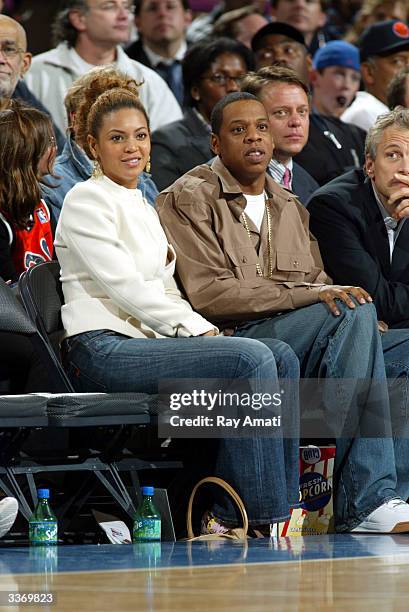 Singer Beyonce and rapper Jay-Z and Infinity Broadcasting CEO John Sykes sit courtside at the New York Knicks v Cleveland Cavaliers game at Madison...