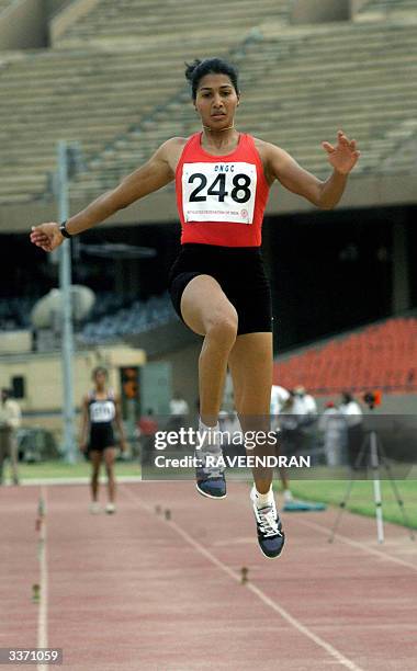 Indian long jumper Anju B. George prepares for her jump during one of her attempts in the National circuit meet in New Delhi ,15 April 2004. Anju,...